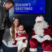 Parents smile with Santa and Louie